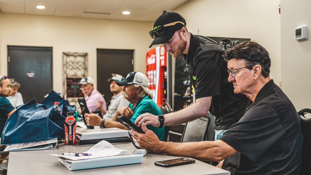 Dillon walking a client through a tablet during a training session.