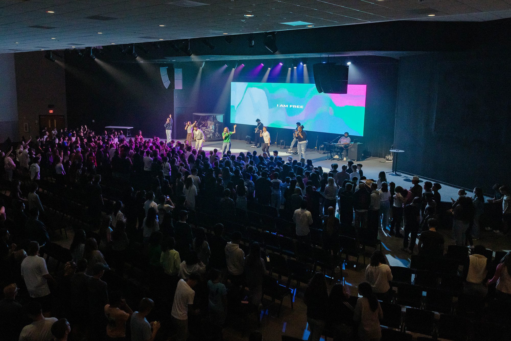 A packed Oaks service, the platform lit and the words I AM FREE on the screen.